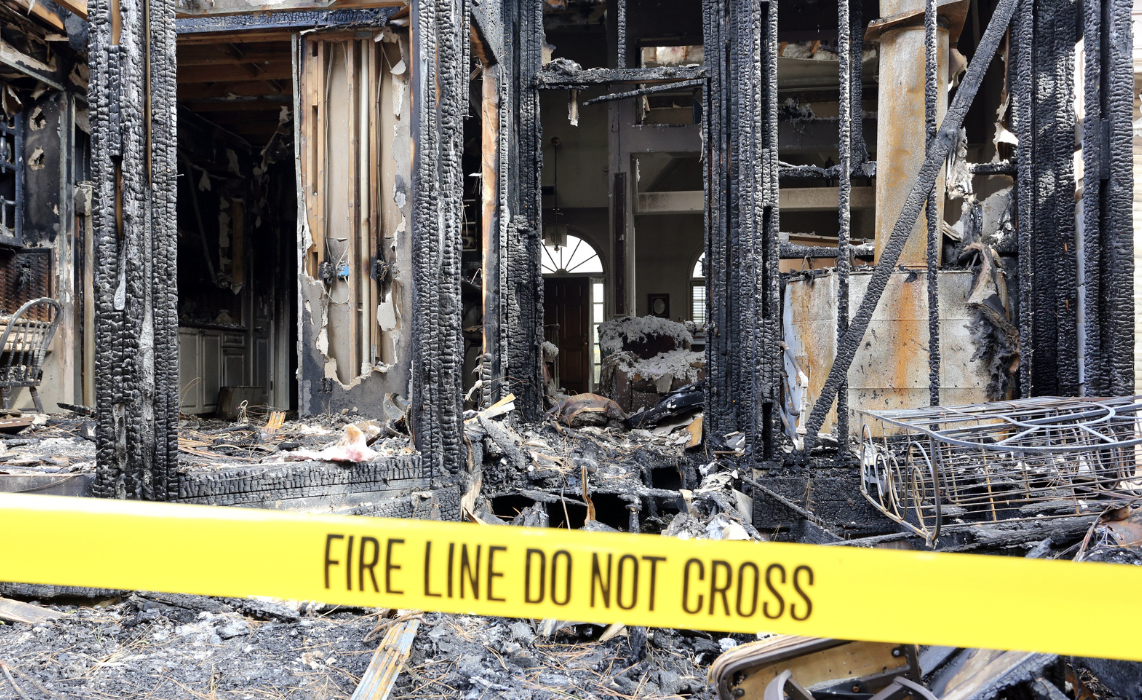 house fire in need of restoration with "fire line do not cross" tape