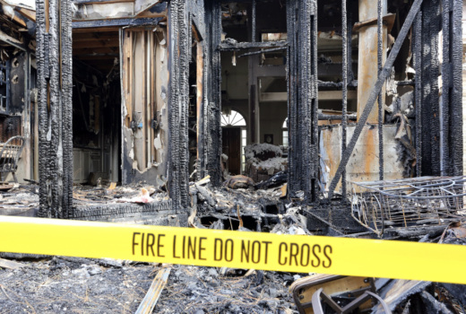 house fire in need of restoration with "fire line do not cross" tape