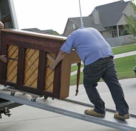 Content Pack-Outs: 2 men loading a piano into a moving truck after home diaster
